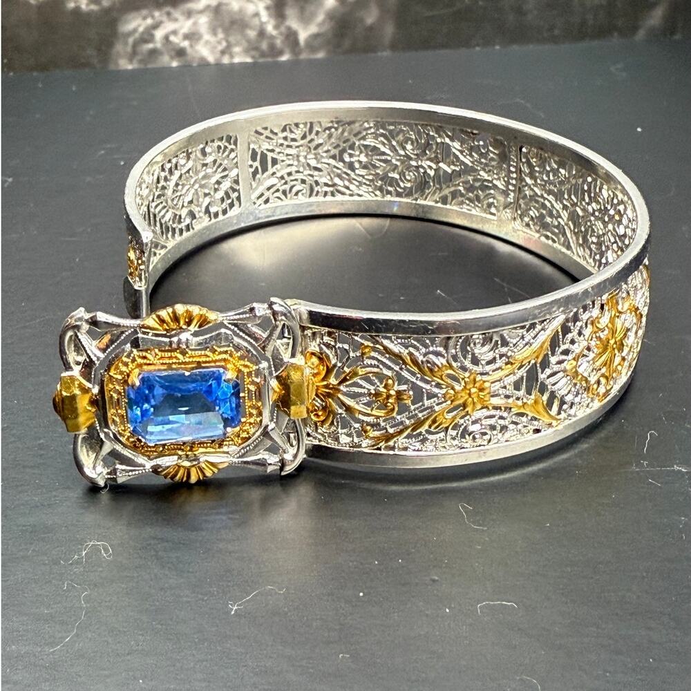1930s Art Deco JJ White Hinged Bangle Blue Glass Stone Gold and Silver Filigree